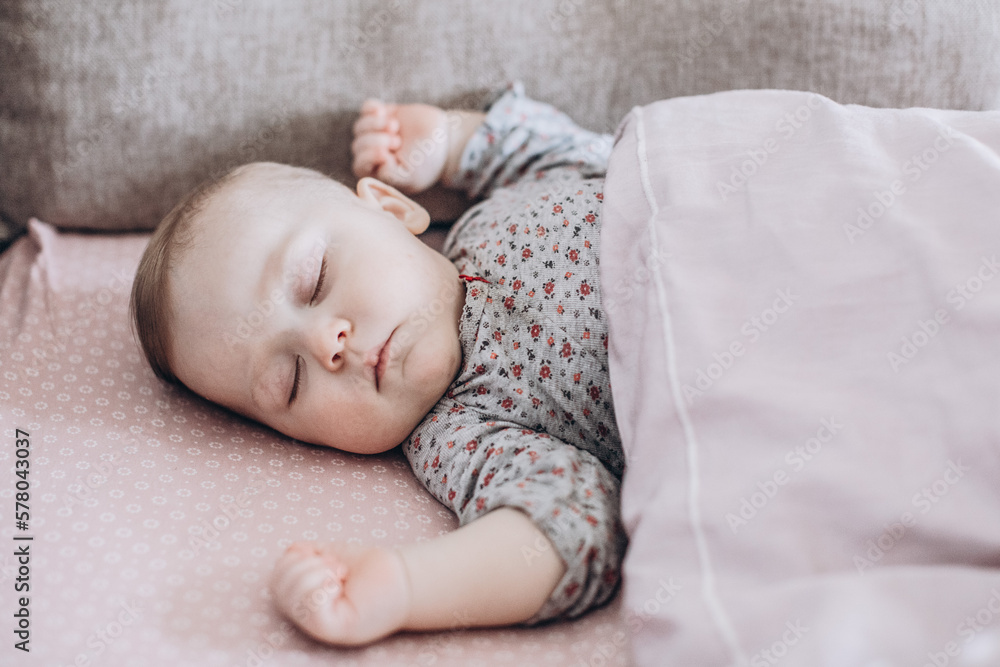 portret small baby sleeps in his babybed portret small baby sleeps in his babybed