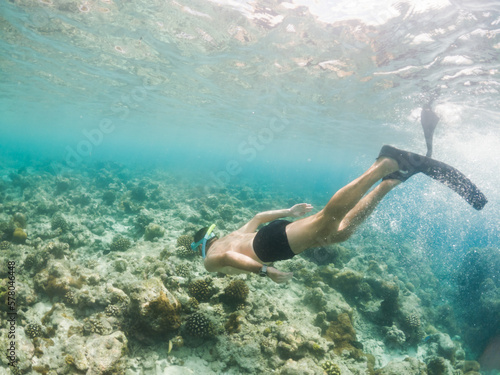 man snorkeling in crystal clear tropical sea