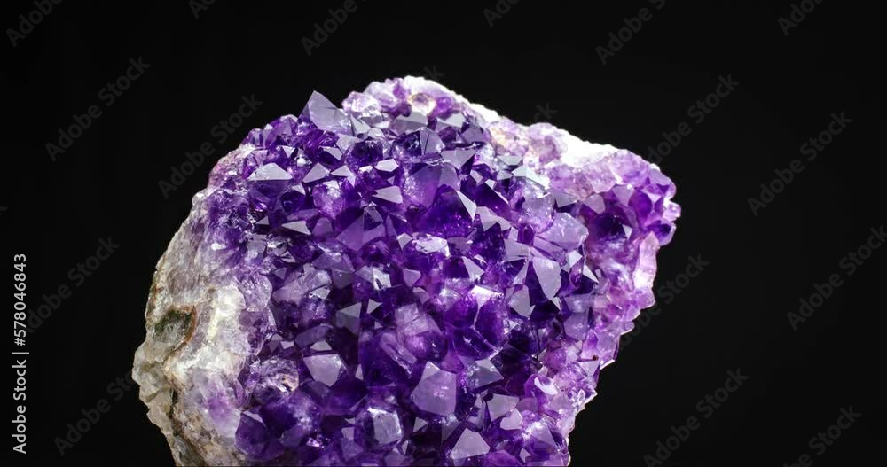 Amethyst geode crystal seamless rotating on black background. macro detail texture background. close-up raw rough unpolished semi-precious gemstone Amethyst geode crystal seamless rotating on black background. macro detail texture background. close-up raw rough unpolished semi-precious gemstone