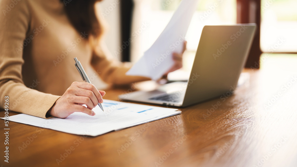 Business Professional Accountant Woman working on laptop computer making research for planning startup at desktop working process in office Business Professional Accountant Woman working on laptop computer making research for planning startup at desktop working process in office