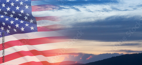 United States of America flag on sky at sunset or sunrise background. Independence day, Memorial day, Veterans day. Banner.