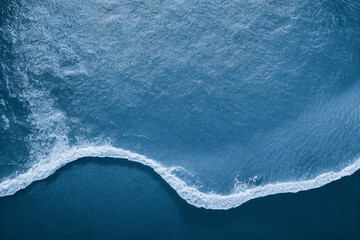 Spectacular aerial top view background photo of ocean sea water white wave splashing in the deep sea. Drone photo backdrop of sea wave in bird eye waves.