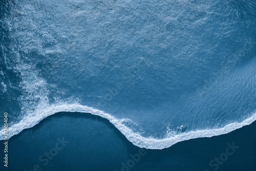 Fototapete Spectacular aerial top view background photo of ocean sea water white wave splashing in the deep sea