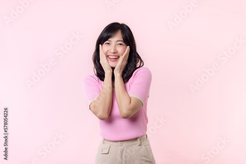Portrait beautiful young asian woman model happy smile in pink sweater casual style fashion isolated on pink studio background. Attractive female person cheerful cute face portrait  Woman day concept.