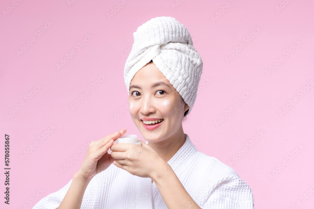 Young asian woman applying facial skincare face cream, cosmetic moisturiser on healthy natural skin make up face. Portrait glowing smile girl person model with care beauty product, spa, cosmetology. Young asian woman applying facial skincare face cream, cosmetic moisturiser on healthy natural skin make up face. Portrait glowing smile girl person model with care beauty product, spa, cosmetology.