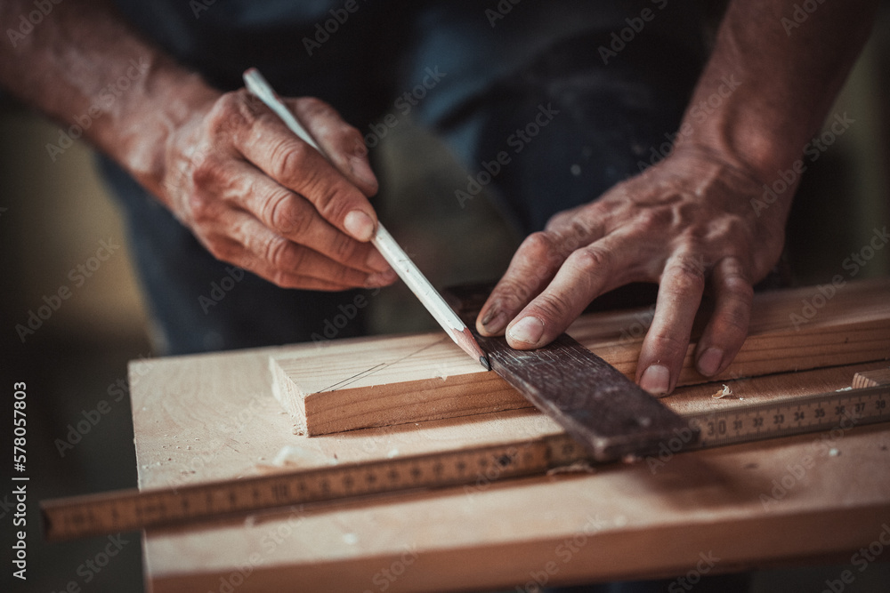 Carpenter using working tools while working on a wood in carpentry workshop Carpenter using working tools while working on a wood in carpentry workshop