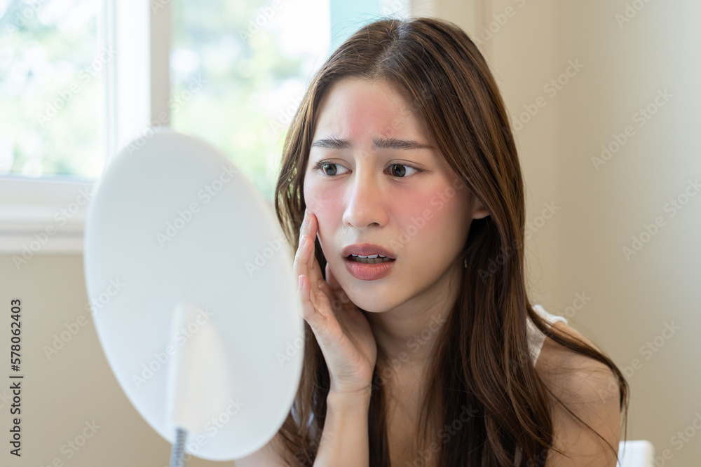 Dermatology, puberty asian young woman, girl looking into mirror