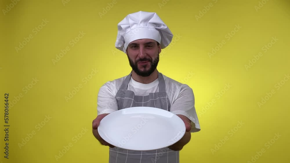 Portrait cheerful man chef holding white empty plate, delighted good smell of dish, enjoying delicious aroma isolated on yellow background. Cooking template pattern, copy space. Food culinary concept Portrait cheerful man chef holding white empty plate, delighted good smell of dish, enjoying delicious aroma isolated on yellow background. Cooking template pattern, copy space. Food culinary concept