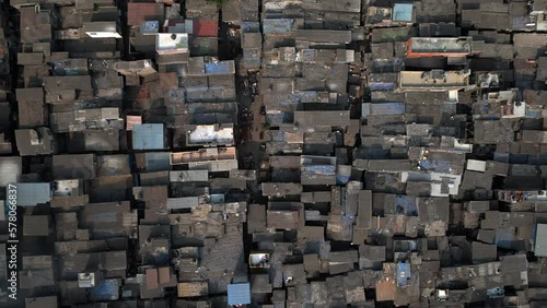 Top down aerial view descending over the Dharavi slums in Mumbai, Maharashtra, India. Dharavi is considered to be one of the largest slums in the world and the largest in Asia.	 photo
