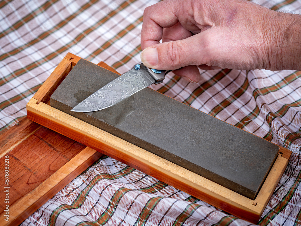 Pocket knife with unique Damascus patter getting a sharpened Pocket knife with unique Damascus patter getting a sharpened