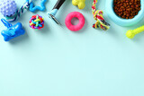 Frame border made of pet toys, accessories and grooming supplies on blue background. Flat lay, top view.