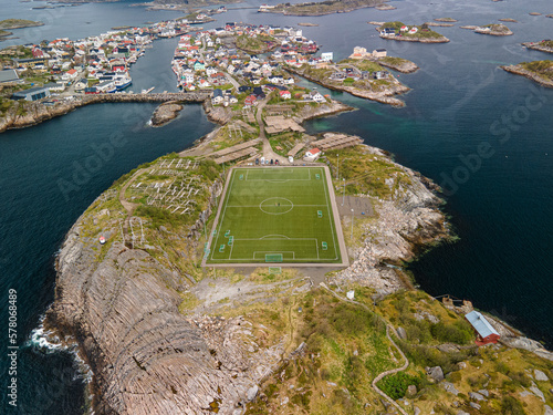 Aerial footage of Henningsvaer Stadium in Lofoten, Norway, during a sunny day with clouds photo