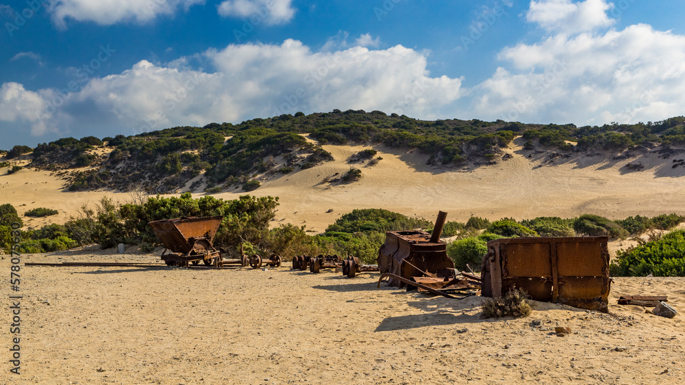 Fototapeta premium Wagons from old mine laying in the sand