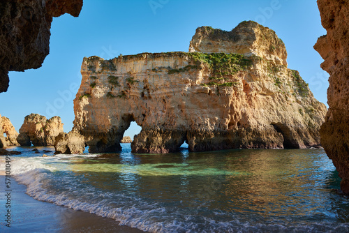 Limestone rock with grottoes washed by the ocean