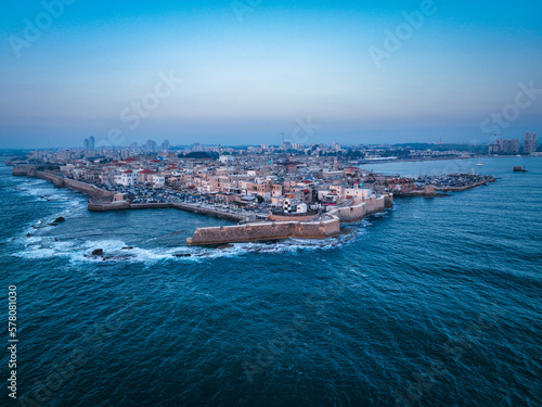 Acre (Akko) is a port city located on the Mediterranean coast and is known for its well-preserved ancient city fortifications. .Aerial footage of the old city, the ancient port and marina.