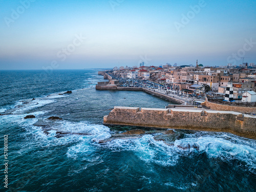 Acre (Akko) is a port city located on the Mediterranean coast and is known for its well-preserved ancient city fortifications. .Aerial footage of the old city, the ancient port and marina.