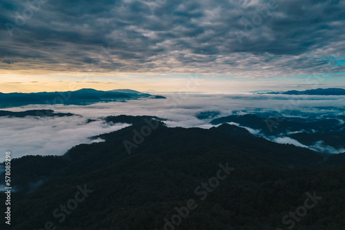 Mountain range and mist with sky and sunrise and surrounding area.