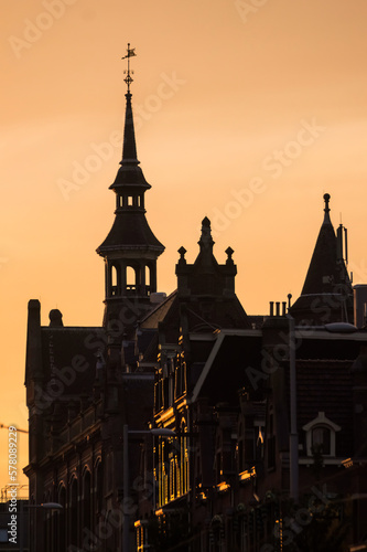 A pink and orange sunset behind a beautiful building in Amsterdam, Netherlands