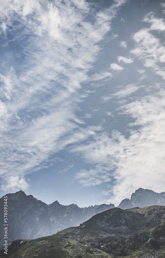 Mountain valley with slopes and rocky cliffs, stone mountain ranges with vegetation, against the background of a cloudy forest sky, mountain summer landscape Mountain valley with slopes and rocky cliffs, stone mountain ranges with vegetation, against the background of a cloudy forest sky, mountain summer landscape