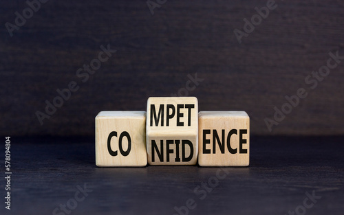 Competence and confidence symbol. Concept word Competence Confidence on wooden cubes. Beautiful black table black background. Business and competence and confidence concept. Copy space. photo