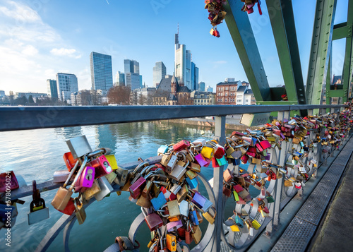 Love Locks at Eiserner Steg (Iron Footbridge) at River Main and skyscrapers skyline - Frankfurt, Germany photo