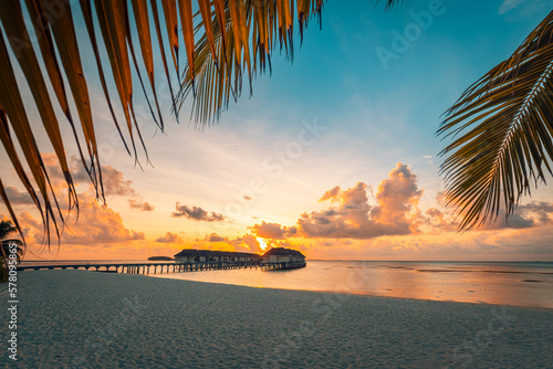 Fototapeta Sunset on Maldives island, luxury water villas resort and wooden pier