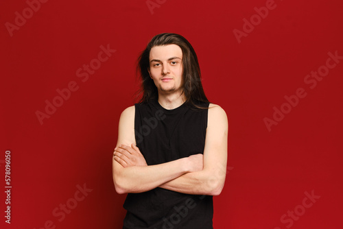 Studio portrait of young handsome man with long black hair © boomeart