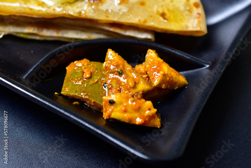Closeup of Mango pickle slices on food plate, aam ka aachar 