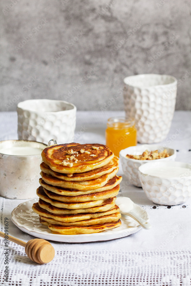 Apple pancakes served with honey, sour cream, nuts, tea and coffee.