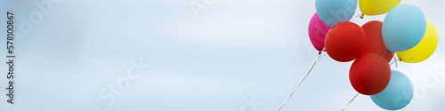 Banner 4x1 for social networks and websites a bunch of colorful balloons against the background of a gray sky photo