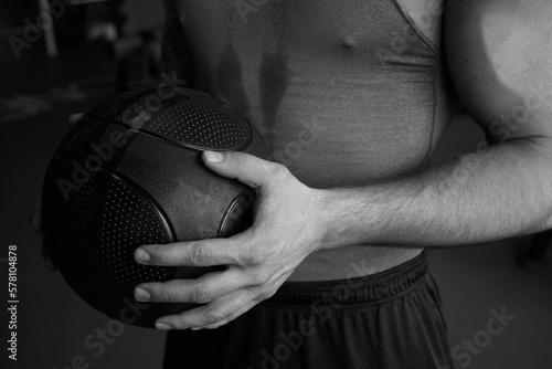 Young male athlete bodybuilder is playing basketball © Richard