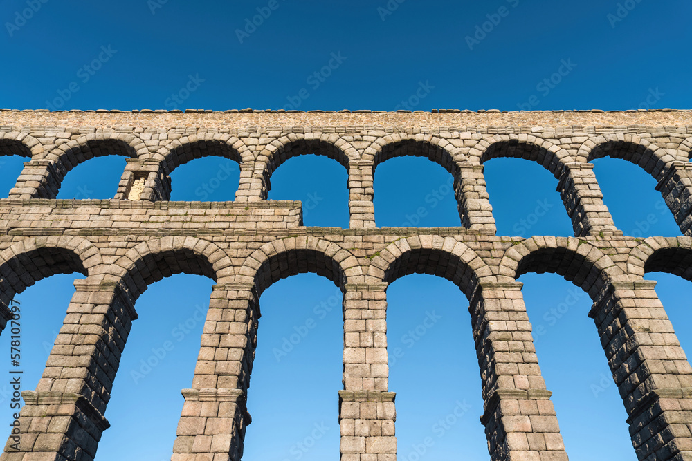 Beautiful Roman aqueduct of Segovia Spain against a blue sky Beautiful Roman aqueduct of Segovia Spain against a blue sky