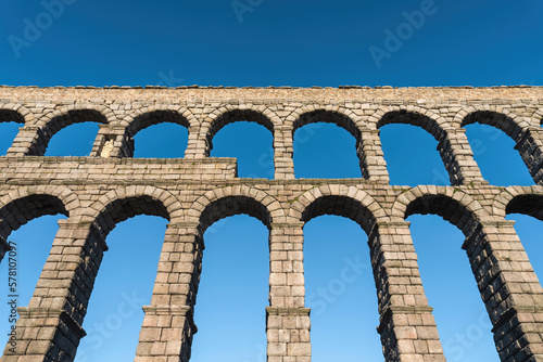 Beautiful Roman aqueduct of Segovia Spain against a blue sky