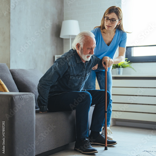 Foto Doctor or nurse caregiver helping senior man with a walking cane stick at home or nursing home