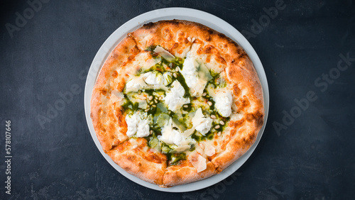 Pizza with spinach, cream cheese, parmesan and pine nuts.
