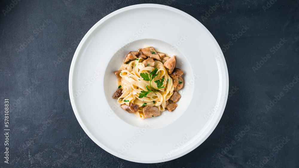 Fettuccine pasta with porcini mushrooms and parsley.