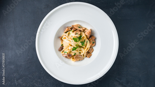 Fettuccine pasta with porcini mushrooms and parsley.