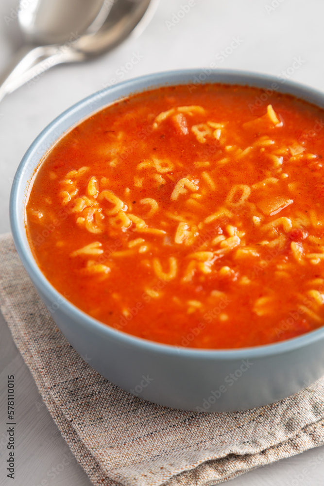 Homemade Alphabet Soup in Tomato Sauce in a Bowl, side view. Homemade Alphabet Soup in Tomato Sauce in a Bowl, side view.