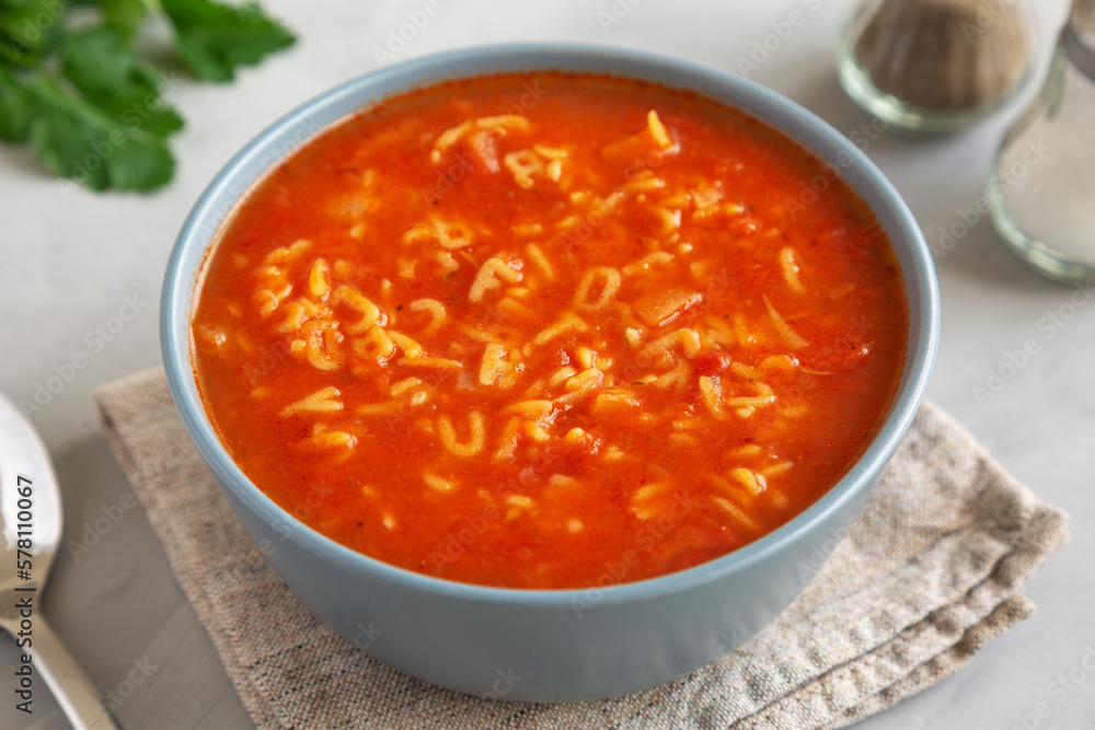 Homemade Alphabet Soup in Tomato Sauce in a Bowl, side view. Homemade Alphabet Soup in Tomato Sauce in a Bowl, side view.