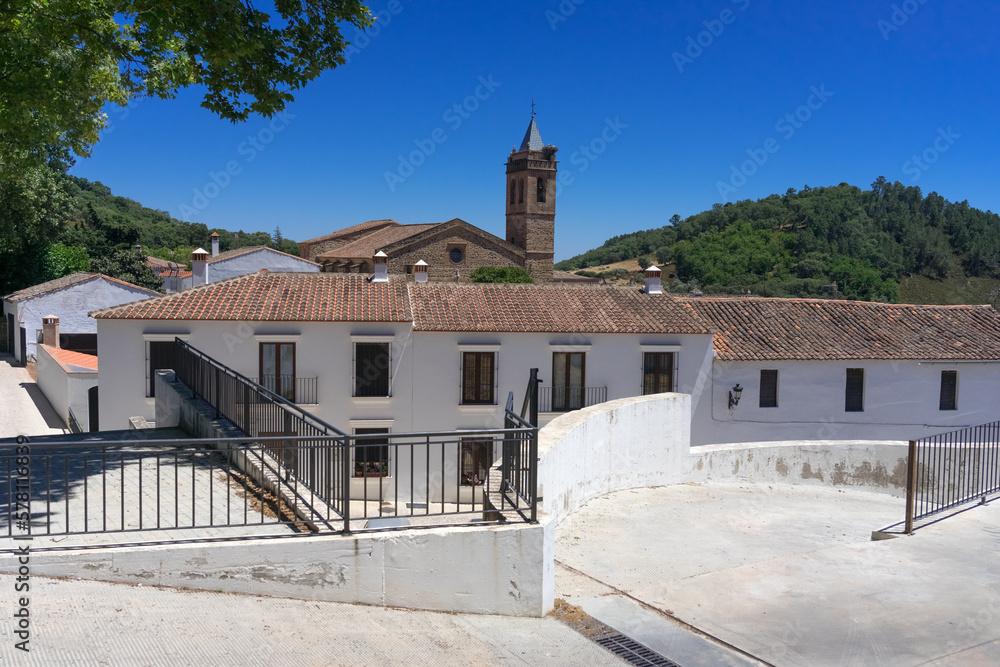Obraz premium Beautiful street with its typical white facadesand the San MArtin church in the background in Almonaster La Real in Huelva province, Andalucia, Spain.