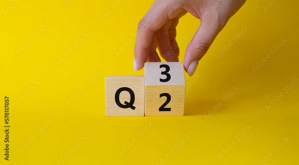 From 2nd Quarter to 3rd symbol. Businessman hand Turnes cube and changes words 2nd Quarter to 3rd Quarter. Beautiful yellow background. Business and Quarter concept. Copy space From 2nd Quarter to 3rd symbol. Businessman hand Turnes cube and changes words 2nd Quarter to 3rd Quarter. Beautiful yellow background. Business and Quarter concept. Copy space