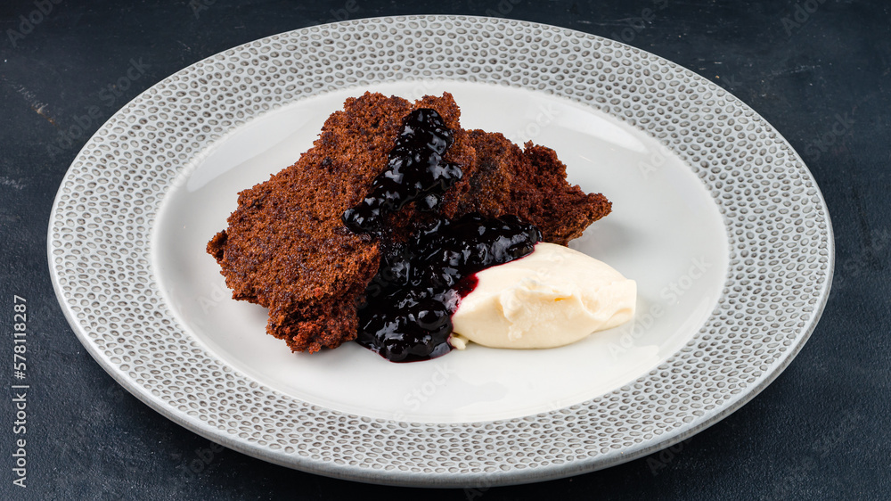 Chocolate brownie dessert with blackcurrant jam and cream cheese. Chocolate brownie dessert with blackcurrant jam and cream cheese.