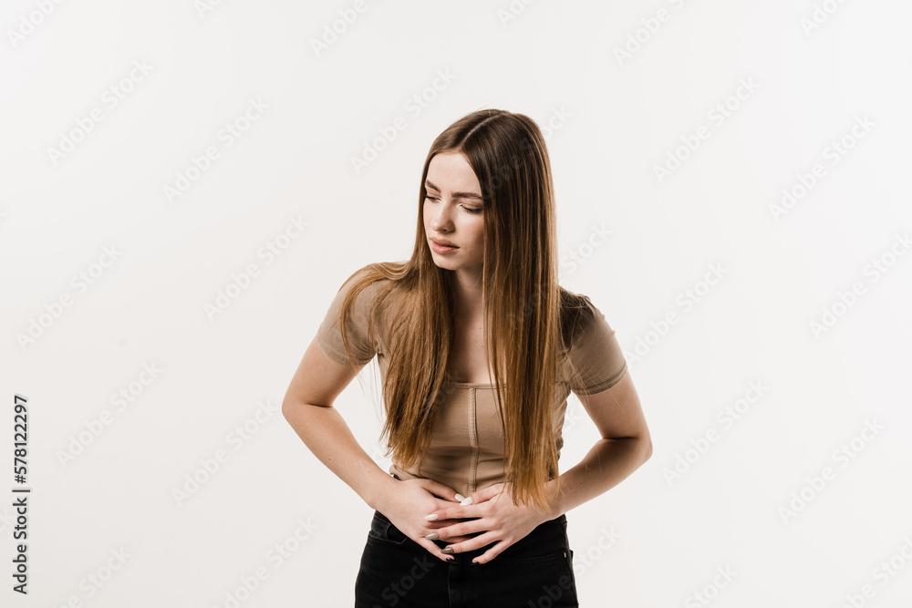 Sick attractive girl hold abdomen because it hurts. Stomach pain. Pancreatitis disease of pancreas becomes inflamed. Sick attractive girl hold abdomen because it hurts. Stomach pain. Pancreatitis disease of pancreas becomes inflamed.