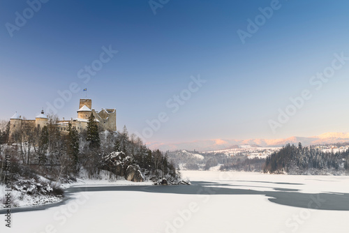 Winter panorama of Niedzica Castle on the River Dunajec. Poland © ysuel