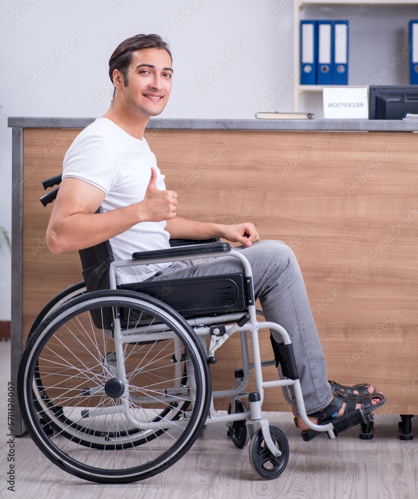 Young man at hospital reception desk Young man at hospital reception desk