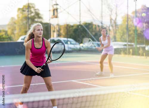 Tennis game - girl actively kicks the ball during a tennis game © JackF