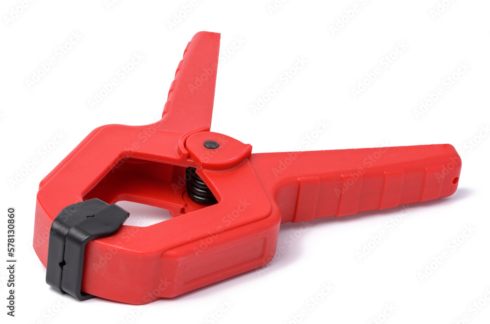 Large red plastic clamp on a white isolated background Large red plastic clamp on a white isolated background