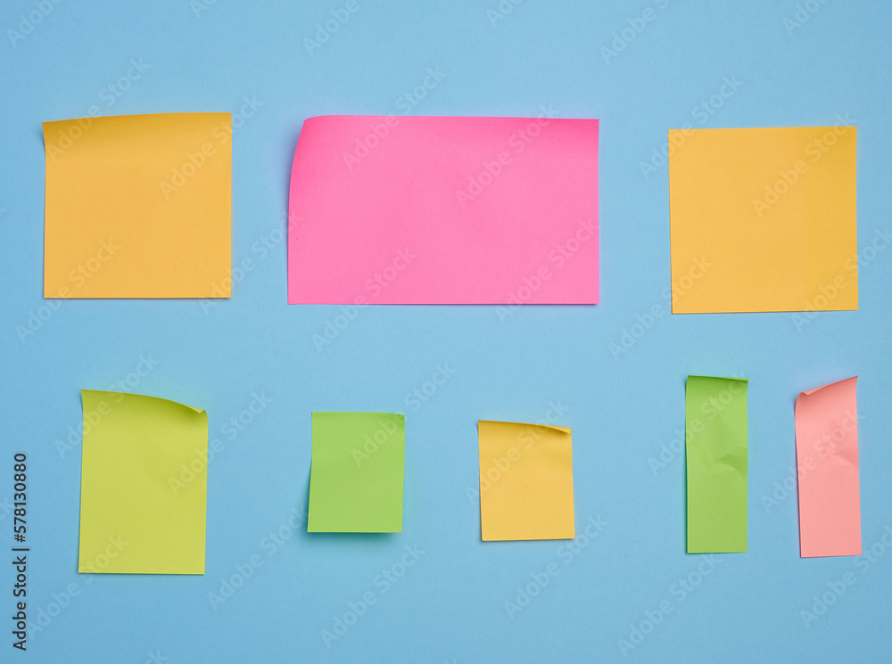 Colorful paper memo holders on blue background, space for writing data, notes Colorful paper memo holders on blue background, space for writing data, notes