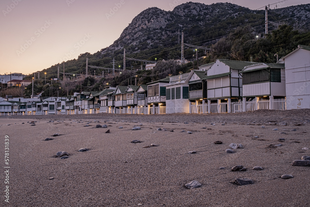 Weekend or vacation cottages overlooking Spain's Garraf beach at dusk.