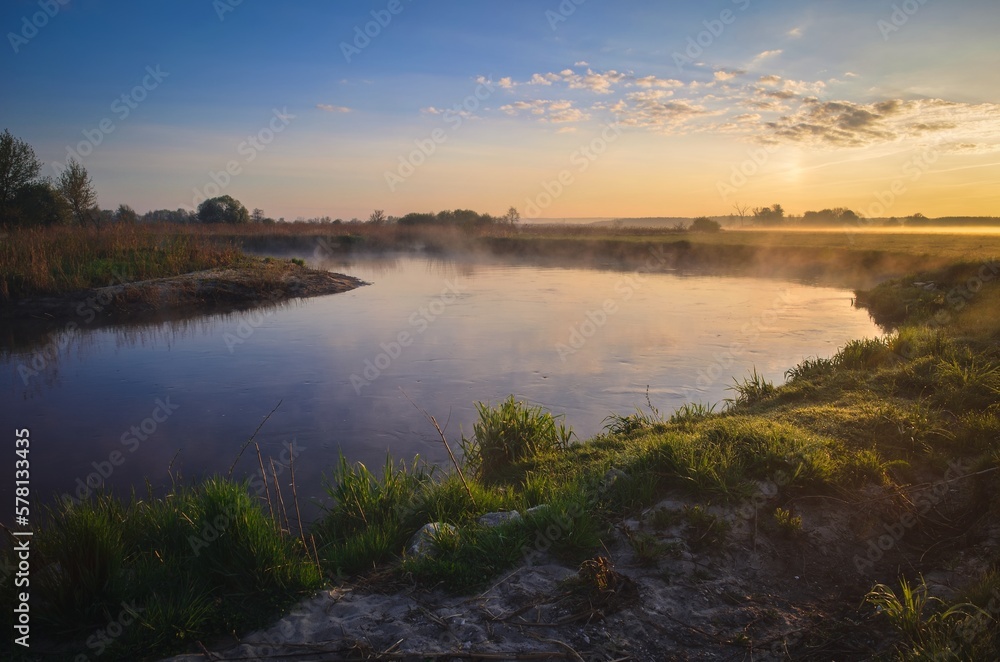 Beautiful morning foggy landscape. Sunrise over the river in Ponidzie in Poland.